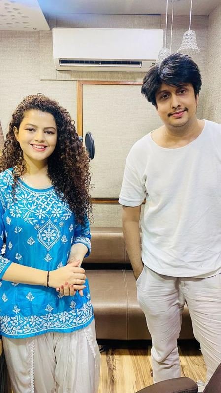 Aslam Keyi with a singer beside a vocal booth