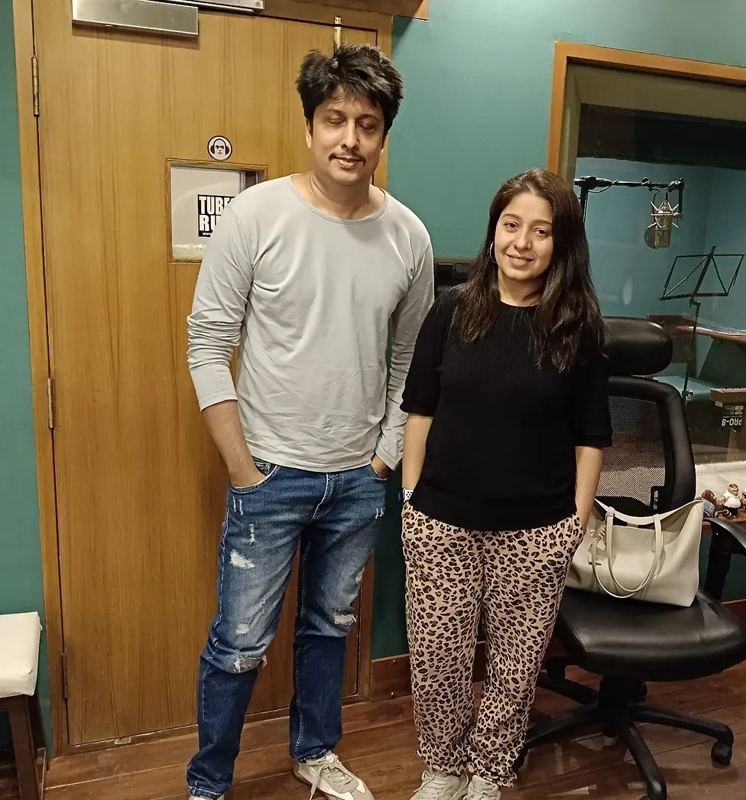 Aslam Keyi with a singer outside a vocal booth